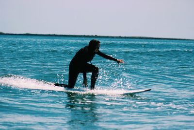 Woman jumping in sea