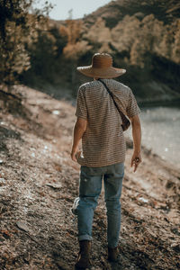 Rear view of man walking in forest