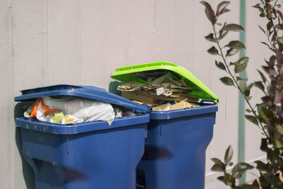 Close-up of garbage bin against wall