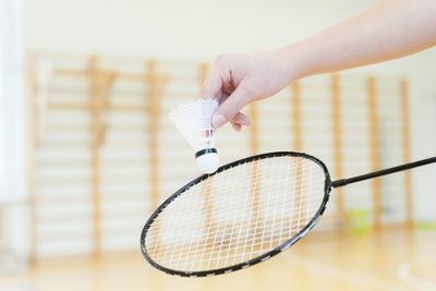 Cropped hand playing badminton