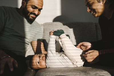 Father and mother with baby on sofa