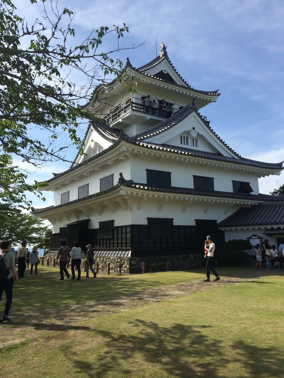 architecture, built structure, building exterior, large group of people, grass, famous place, place of worship, religion, person, sky, travel destinations, tourism, history, spirituality, men, travel, lifestyles, leisure activity