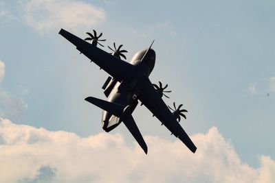 Low angle view of airplane against sky