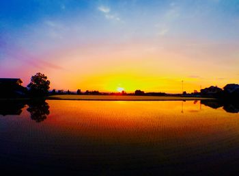 Scenic view of lake at sunset