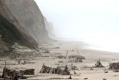 Scenic view of beach against sky during winter