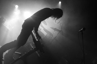 Tilt image of silhouette pianist performing during music festival