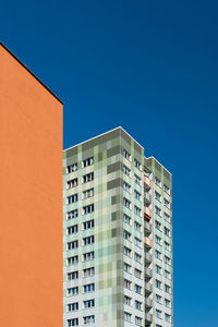 Low angle view of modern building against clear blue sky
