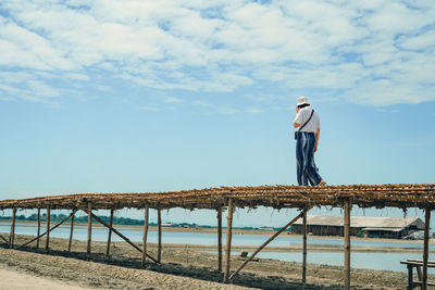 Rear view of man standing on beach