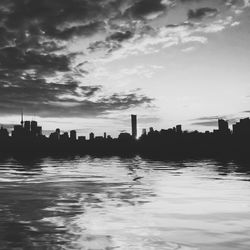 View of cityscape against cloudy sky