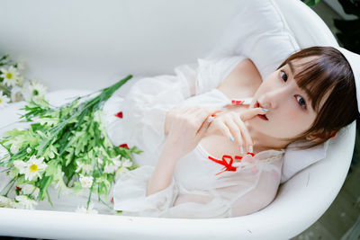 High angle view of young woman in bathtub