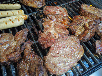 High angle view of meat on barbecue grill