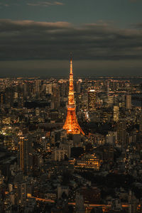 Illuminated cityscape against sky at night