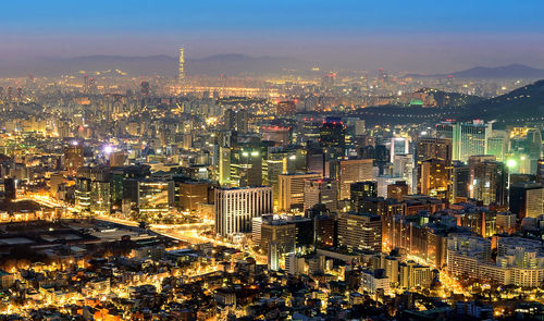 Aerial view of city lit up at night