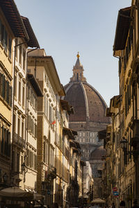 View down a busy street with city view of duomo in florence italy