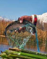 Fisherman fishing trout uro lake titicaca 