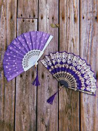 Close-up of hand fan on wooden table