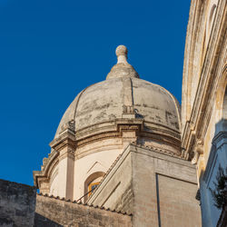 Low angle view of building against blue sky