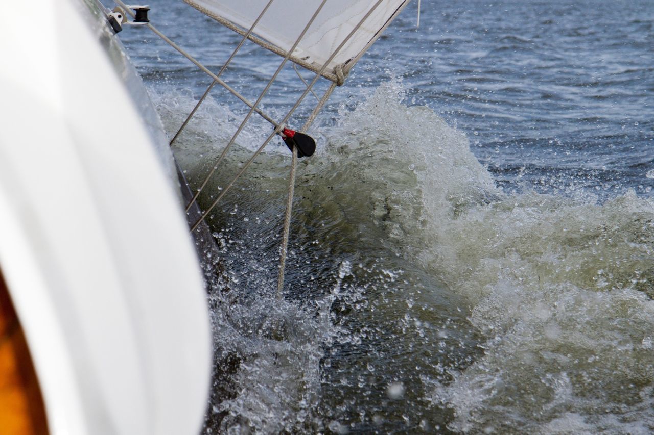 water, high angle view, transportation, reflection, nautical vessel, lake, rippled, day, mode of transport, boat, lifestyles, leisure activity, waterfront, river, unrecognizable person, outdoors, nature, bird