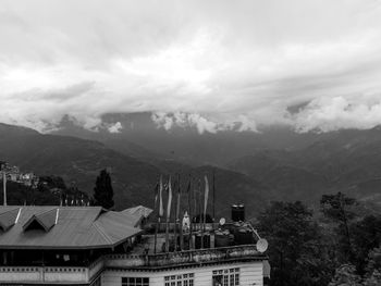 High angle view of buildings against cloudy sky
