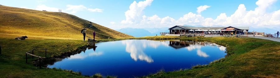 Panoramic view of lake and houses against sky