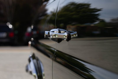 Close-up of car on road