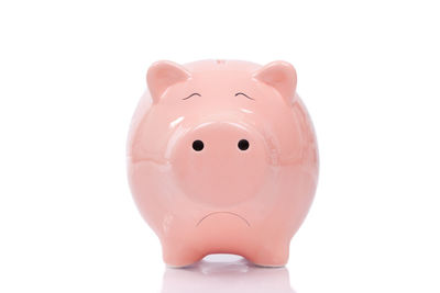 Close-up of pink candle against white background