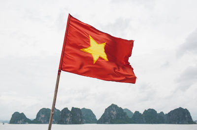 Vietnamese flag waving against sky