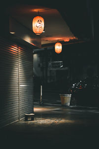 Illuminated lantern on table at night