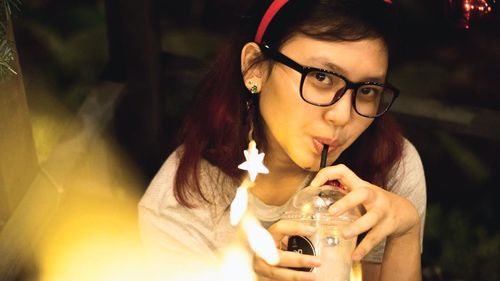 Portrait of young woman drinking coffee