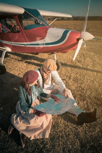 High angle view of people sitting on land