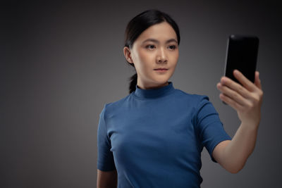 Portrait of mid adult man using mobile phone