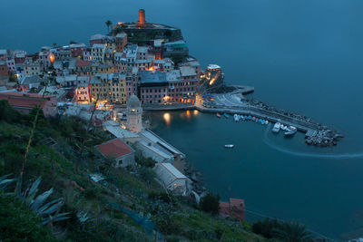 High angle view of harbor in town at dusk