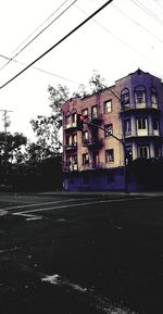 Road by building against sky