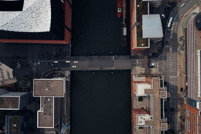 Aerial view of buildings by road and canal in city