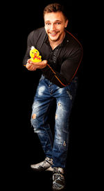 Portrait of smiling man holding umbrella against black background