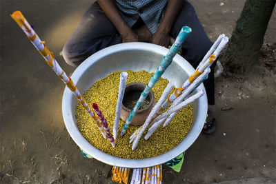 High angle view of paper rolls in food container by vendor on footpath