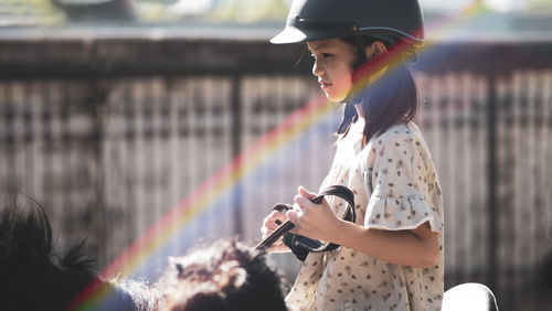 Side view of woman looking at camera