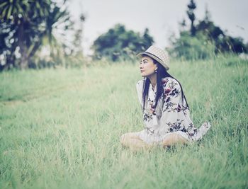 Young woman wearing hat on field
