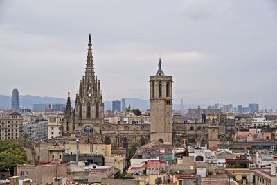 View of buildings in city against sky