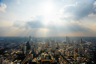 Aerial view of modern buildings in city against sky