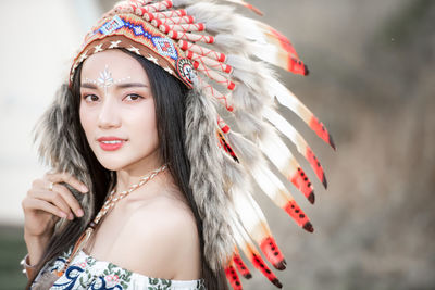 Boho bohemian girl styled wearing indian maxi dress and jewellery in autumn field