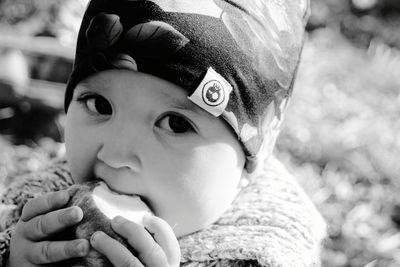 Close-up portrait of cute boy drinking outdoors