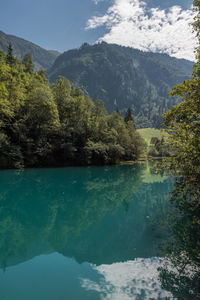 Scenic view of lake and mountains against sky