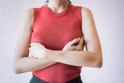 Midsection of woman standing against white background