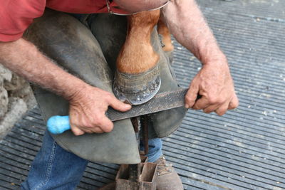 Low section of man working on grill