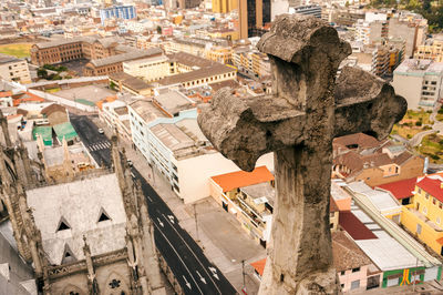 High angle view of cross and buildings in city