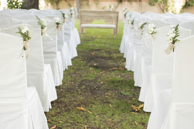 High angle view of white chairs arranged at wedding ceremony