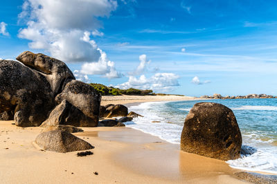 Rocks on beach against sky