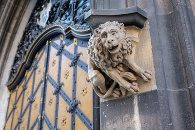 Stone lion beside door and facade new city hall munich close-up