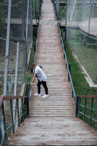 Rear view of man walking on staircase